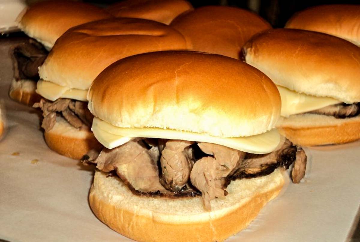 Italian Beef sandwiches on plate with au jus sauce