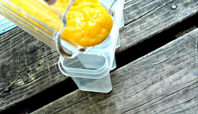 Mango getting poured into popsicle molds 