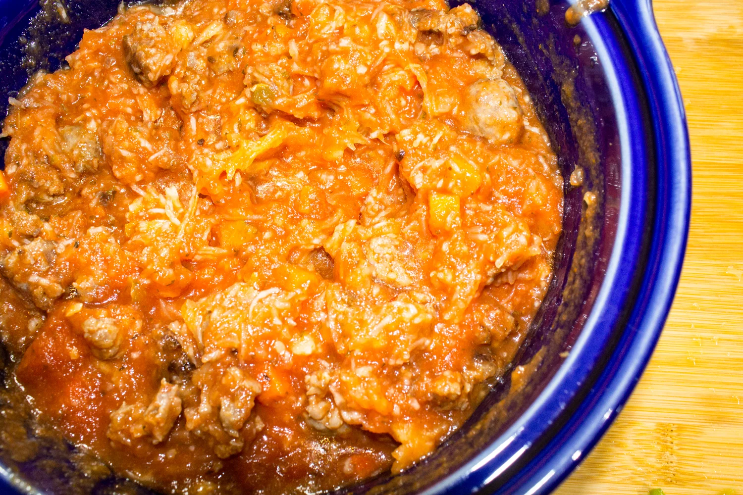 veggies in casserole dish with peppers, sauce, and meat