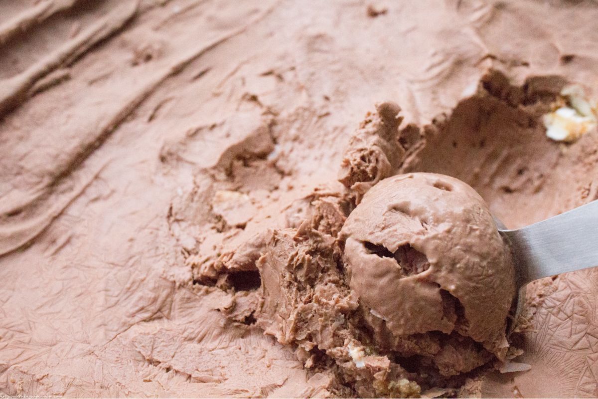 scooping out frozen creamy keto chocolate ice cream