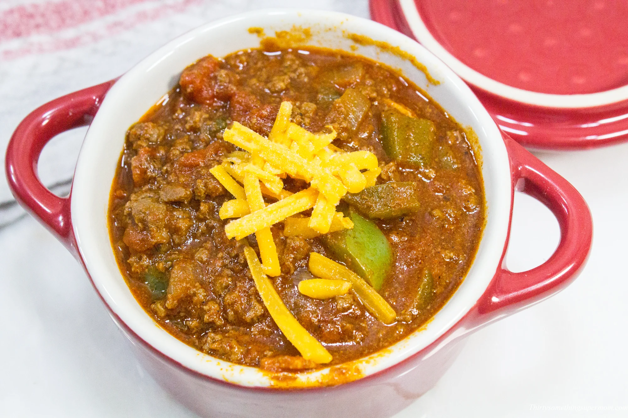 mini dutch oven topped with cheese. 