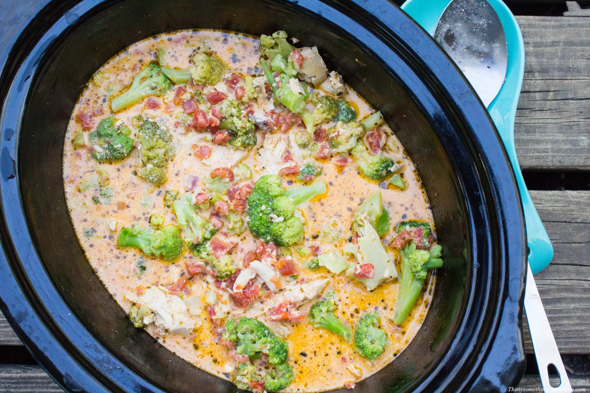 slow cooker with chicken, diced tomatoes, and broccoli