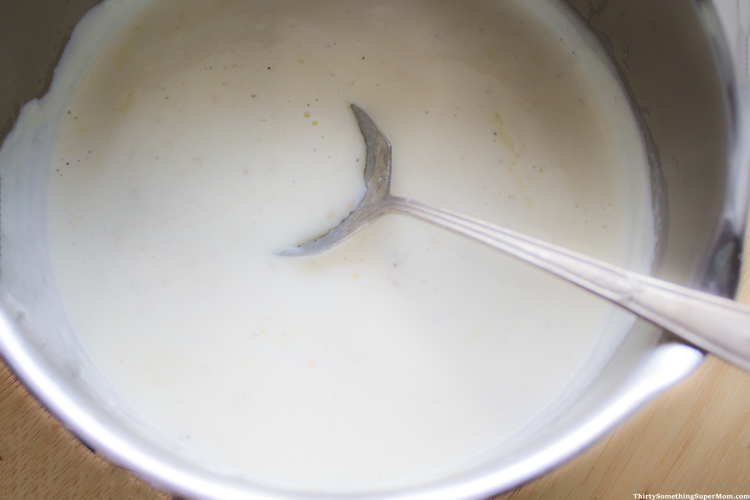homemade alfredo in mixing bowl becoming creamy