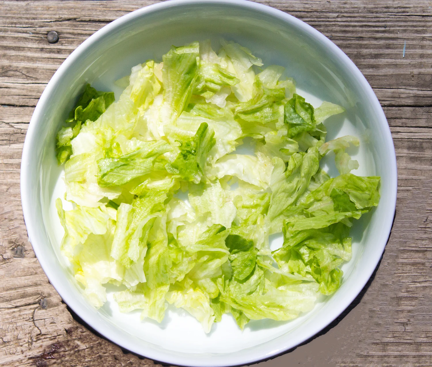 lettuce in bowl, assembling the salad 