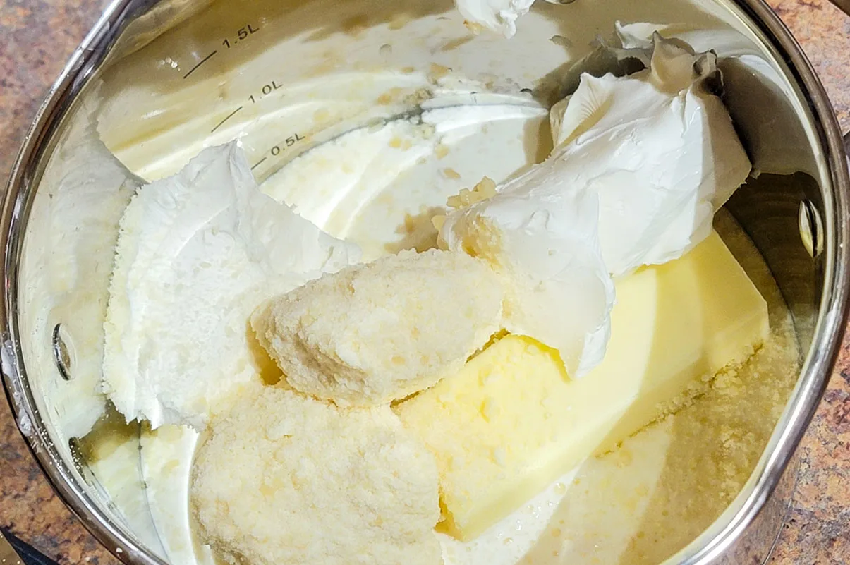 heavy cream, butter, almond flour, garlic, in pot.
