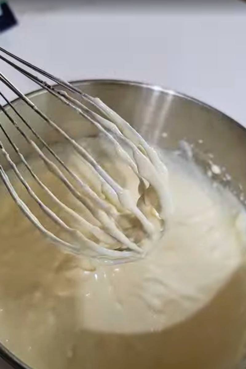 mixing cream cheese, egg, and ricotta in ziti