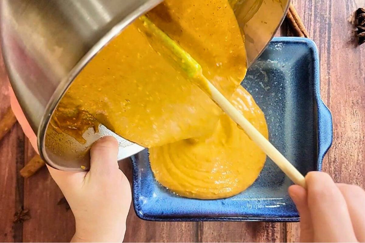 pumpkin filling pouring into baking dish